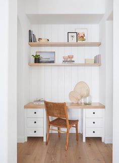 a chair sitting on top of a wooden floor next to a shelf filled with books