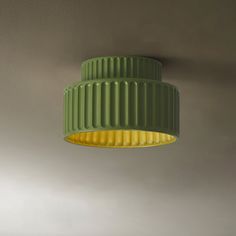 a green and yellow lamp hanging from the ceiling