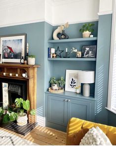 a living room filled with furniture and a fire place under a painting on the wall