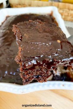 a close up of a piece of chocolate cake on a plate with a spatula