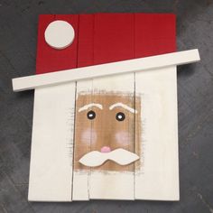 a piece of wood that has been cut out to look like a santa clause on it