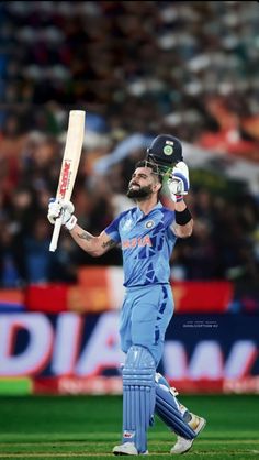 a man with a beard holding a cricket bat in his hand while walking across a field