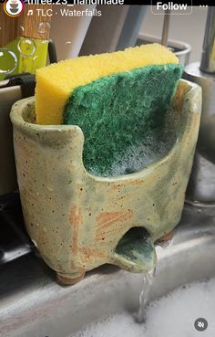 a close up of a sponge in a cup on a sink