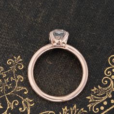 It doesn't get more classic than this! A sweet rose gold solitaire with a 1.51ct old mine cut diamond, a bright and shining GIA J color and VS2 clarity. The stone has very classic old mine faceting in an ever-so-slightly elongated, cushiony shape which we just adore. The rose gold leans into that antique gold which always has a touch of rosy color, with double claw prongs holding her together at the corners. 14kt rose gold Size 4.75 & resizable Diamond measures 7.26 x 6.62 x 4.36 mm GIA report l Heirloom Rose Gold Diamond Ring With Single Diamond, Timeless Rose Gold Moissanite Wedding Ring, Rose Gold Wedding Band With Rose Cut Diamonds, Solitaire 14k Rose Gold Round Wedding Ring, 14k Rose Gold Solitaire Wedding Ring, Timeless Single Diamond Rose Gold Wedding Ring, Classic Rose Gold Asscher Cut Wedding Ring, Timeless Rose Gold Wedding Ring With Single Diamond, Classic Asscher Cut Rose Gold Wedding Ring