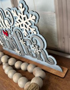 a wooden sleigh with snowflakes on it and some balls in the foreground