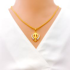 This tasteful Khanda pendant, made from 22k gold and weighing 3.8 grams, showcases an elegant dual-tone design with a primary yellow gold finish. Measuring 1.25 inches in length, it represents a blend of spiritual significance and contemporary style, embodying the essence of Sikh courage and remembrance. Ideal for those who appreciate symbolic jewelry with modern aesthetics, this dual-tone Khanda pendant is a meaningful addition to any collection, offering a touch of grace and tradition. PRODUCT DETAILS Gold Purity(karat): 22k Gold Weight(grams): 3.8 Item Finish: Yellow Gold Pendant Length: 1.25" Chain: Not Included Dual-tone Gold Temple Necklace As Gift, Dual-tone Gold Plated Necklace, Dual-tone Yellow Gold Temple Jewelry Necklace, Yellow Gold Dual-tone Temple Jewelry Necklaces, Yellow Gold Dual-tone Temple Jewelry Necklace, White 22k Gold Temple Necklace As Gift, White 22k Gold Temple Necklace Gift, 22k Gold Dual-tone Necklace Gift, Dual-tone 22k Gold Necklace For Gifts