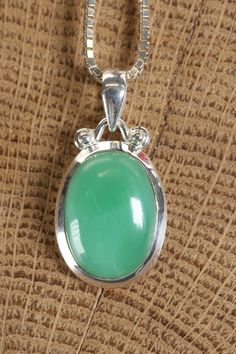 Chrysoprase Pendant Approx. Dimensions: 24x16x8 mm This pendant is made with .925 Sterling Silver. Chain is not included. Chrysoprase is a type of chalcedony, which is a variety of microcrystalline quartz, known for its distinctive apple-green color. It is considered a gemstone due to its attractive appearance and is often used in jewelry and ornamental objects. The green color of chrysoprase is attributed to the presence of nickel impurities within the mineral.Chrysoprase can vary in color inte Oval Jade Cabochon Necklace, Oval Jade Cabochon Necklaces, Jade Cabochon Oval Pendant Necklace, Green Chrysoprase Oval Pendant Jewelry, Oval Chrysoprase Gemstone Necklace, Oval Chrysoprase Gemstone Necklaces, Chrysoprase Gemstone Oval Pendant Necklace, Chrysoprase Oval Pendant Necklace As Gift, Oval Cabochon Jade Jewelry Gift