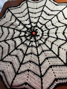 a crocheted spider web umbrella on a table