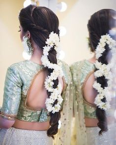 two women with flower leis in their hair