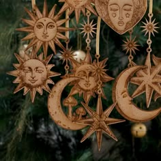 an ornament hanging from a christmas tree decorated with sun and moon faces, stars and crescents