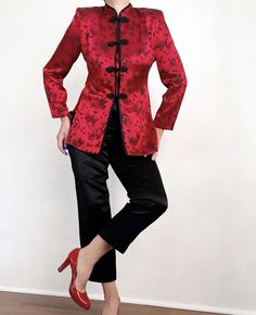 "A beautiful Vintage Asian Chinese Satin combination that will bring you stylish through your next event. The blazer comes along in a wonderful, warm red tone with an Asian style print in black, shoulder pads and front toggle closure. Super soft and comfortable to wear. The black satin pants feature an elastic waist and a bootcut style. So soft with a gorgeous shine. This Vintage combo is awesome together or seperate, styled with denim or leather, totally up to your liking. The options are endle Elegant Red Outerwear With Stand Collar, Red Fitted Blazer With Stand Collar, Red Spring Wedding Outerwear, Black Satin Pants, Satin Pant, Suit Vintage, Red Tone, Satin Noir, Satin Pants