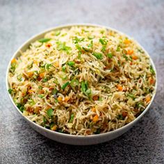 a white bowl filled with rice and vegetables