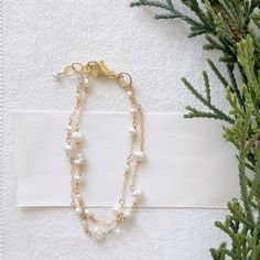 "Poppy Linen Bracelet" is perfect for our pearl lovers out there. Dainty and simple yet makes a beautiful statement. Pair it with a classic Caroline bangle for an elevated look. - Two strands of dainty white pearls in various shapes and sizes are accented by small chain. Small, faceted crystal quartz add a hint of shimmer. - adjustable, 6.75-7.25 inches - Available in 14K gold filled and sterling silver, for more information on our metals click HERE! Elegant Hypoallergenic Rosary Bracelet With Round Beads, Adjustable 14k Gold-filled Elegant Pearl Bracelet, Elegant Hypoallergenic Rosary Bracelet, Elegant White Pearl Bracelet In 14k Gold, Elegant 14k Gold Filled Pearl Bracelet, Pearl Oyster Bracelet For Anniversary, Elegant Hypoallergenic Round Rosary Bracelet, Elegant Pearl Rosary Bracelet With Pearl Charm, Delicate Pearl Jubilee Bracelet