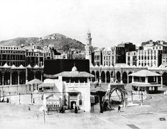 an old black and white photo of a city with lots of buildings in the background