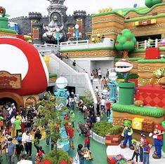 the entrance to mario's mushroom land at disneyland california adventure park is decorated in green, yellow and red