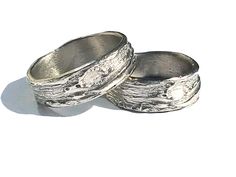 two silver rings sitting on top of each other