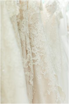 wedding gowns are lined up in rows