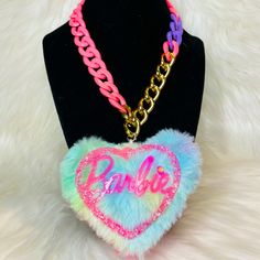 Keeping Barbie Close To Your Heart Has Never Been Easier Because Now We Bring You This Beautiful Handmade Barbie Necklace. It Features A Gorgeous Pink Barbie Doll Logo In Acrylic Surrounded By Multi Colored Fur In The Shape Of A Heart With A Multicolor Chain. This Necklace Is Definitely A Eye Catcher And Plays Well With Multiple Outfits. Cute Pink Jewelry With Chain, Cute Pink Jewelry With Chain Detail, Trendy Personalized Pink Necklace, Pink Barbie Doll, Barbie Necklace, Barbie Jewelry, Baby Alive Doll Clothes, Fandom Jewelry, Irregular Choice Shoes