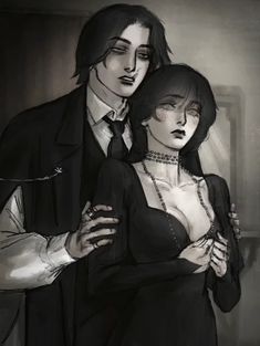 a man and woman dressed in black standing next to each other with their arms around each other