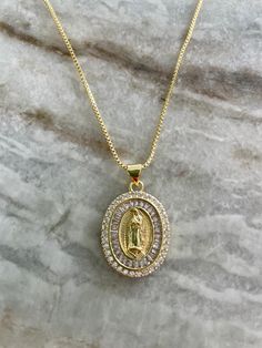 Lady of Guadalupe Medal with Optional Cross and Swarowski Birthstone.  Lady of Guadalupe Medal Measures 1 inch from the very top of the loop to the bottom of the medal. To ADD MORE BIRTHSTONES use the link below.  No worries.... The birthstone will be gold even though the link is for the silver. https://www.etsy.com/listing/774404837/add-a-birthstone-charm Gold Oval Rhinestone Jewelry, Gold Oval Jewelry With Rhinestones, Lady Of Guadalupe Necklace, Religious Jewelry Catholic, Guadalupe Necklace, Catholic Medals, Our Lady Of Guadalupe, Catholic Jewelry, Lady Of Guadalupe