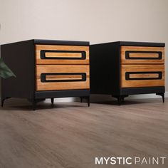 two black and wood dressers sitting next to each other on a hard wood floor