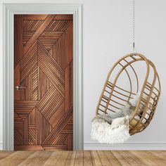 a wooden door with a hanging chair in front of it and a white rug on the floor