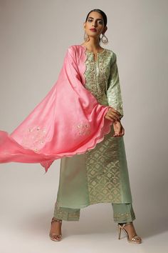 Green kurta with embroidered floral motifs on yoke and sleeves hem. Paired with embroidered hem pant and floral embroidered scallop hem pink dupatta.
Components: 3
Pattern: Embroidered
Type Of Work: Floral
Neckline: Notched
Sleeve Type: Full
Fabric: Silk Chanderi
Color: Green
Other Details: 
Scallop dupatta
Semi elasticated pant
Occasion: Puja - Aza Fashions Pista Green Intricately Embroidered Chanderi Palazzo Set, Pista Green Chanderi Sharara With Embroidered Border, Pista Green Intricate Embroidery Chanderi Palazzo Set, Pista Green Sharara With Embroidered Border, Intricate Embroidery Churidar With Traditional Drape, Green Floral Embroidery Churidar, Designer Pista Green Unstitched Suit With Embroidered Border, Elegant Dola Silk Kurta With Embroidered Border, Pista Green Embroidered Sharara For Wedding