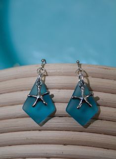 - Coastal Sea Glass Earrings - If you're looking for a beachy pair of earrings, you've just hit the jackpot! Frosted glass and cute coastal charms make these earrings perfect for wearing on that vacation you've been dreaming of...or maybe just to make you feel like you're on vacation :) If you have any questions, message me! Be sure to check out my Instagram page: @thecreativeoutlet19 Beach Earrings With Sea Glass And Ear Wire, Beach Sea Glass Earrings With Ear Wire, Summer Glass Earrings For Gift, Summer Starfish Charm Dangle Earrings, Summer Dangle Earrings With Starfish Charm, Summer Beach Earrings With Starfish Charm, Glass Dangle Earrings For The Beach, Turquoise Earrings For Beach, Turquoise Beach Earrings