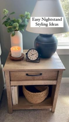 a night stand with a lamp and a clock on it