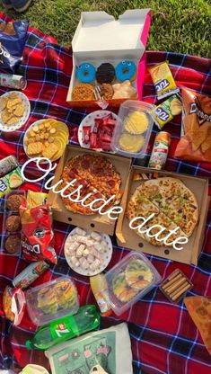 a picnic blanket covered in food and snacks