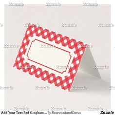 a red and white gingham checkered card with a blank label on it