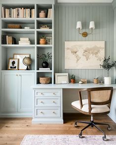 a home office with blue painted walls and white furniture