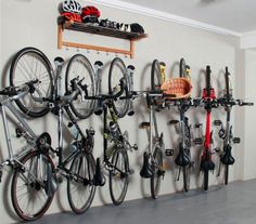 there is a bike rack with many bikes hanging on the wall next to it,