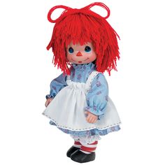 a doll with red hair wearing a blue dress