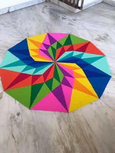 a multicolored umbrella on the ground in an empty room