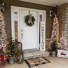 the front door is decorated with christmas trees and wreaths