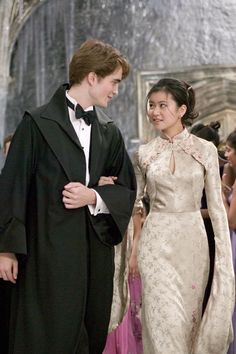 a young man and woman dressed in formal wear