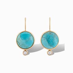 Inspired by our statement Dropping Circles earrings, we designed the Tiny Mini Drops to be worn with all your everyday looks. Each semi-precious gemstone sits next to a small cubic zirconia cabouchon for a subtle pop of sparkle. Add them to any outfit for colorful fun! Details Lightweight drop earrings Made of genuine mohave turquoise and cubic zirconia stone Set in 14k gold plated brass Dimensions: 5/8" Wide x 1 1/8" Long Luxury Earrings With Natural Stones, Luxury Round Earrings With Natural Stones, Elegant Turquoise Diamond Earrings, Luxury Turquoise Gemstone Earrings, Elegant Turquoise Jewelry With Bezel Setting, Elegant Turquoise Earrings With Gemstone Accents, Fine Jewelry Earrings With Natural Stones, Modern Turquoise Round Earrings, Turquoise Drop Earrings With Gemstone Accents