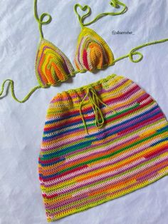 two crocheted swimsuits are laying next to each other on a white sheet