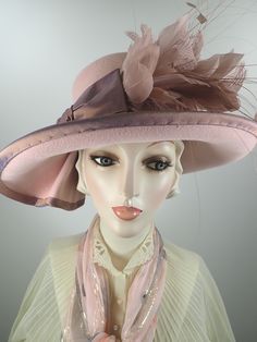 You'll look great in this pretty pink wool felt hat! It can easily transition from Winter to early Spring and is perfect for any dressy occasion. Imagine walking into church with this beauty! The flattering asymmetrical wide brim hat turns up on the left and slopes down on the right. A unique folded pleat adorns the brim. It's topped with a gorgeous mauve/pink band and bow. This hat that will be the envy of everyone who see it! The hat itself is pink wool felt and the crown (top) is slightly dom Luxury Wool Party Hats, Spring Hat, Spring Hats, Dupioni Silk, Pink Feathers, Church Hats, Mauve Pink, Felt Hat, Wide Brimmed Hats