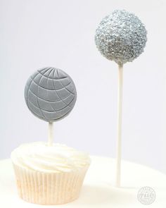 two cupcakes with silver frosting on top