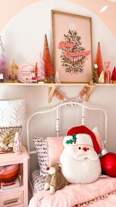 a bedroom decorated for christmas with pink and white decor, including a santa clause pillow