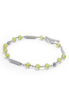 Smooth peridot beads bring a pretty pop of color to this sterling silver toggle bracelet sprinkled with signature Caviar beaded stations. Sterling silver/peridot Imported Gold-colored Sterling Silver Pearl Bracelet, Elegant Luxury Peridot Bracelets, Silver Peridot Gemstone Bracelets, Gold Peridot Jewelry With Polished Finish, Nickel-free Silver Peridot Jewelry, Toggle Bracelet, Womens Jewelry Bracelets, Color Pop, Nordstrom