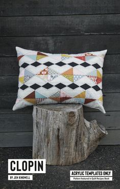 a pillow sitting on top of a wooden stump