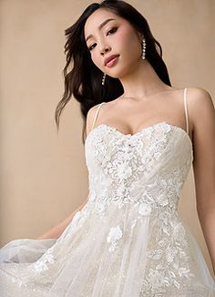 a woman in a wedding dress posing for the camera