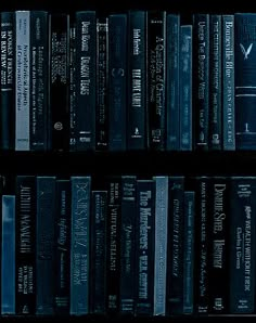 a book shelf filled with lots of books on top of each other in front of a black background