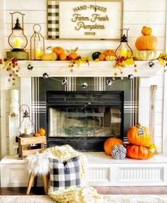 a fireplace decorated for fall with pumpkins, candles and other decorations on the mantle