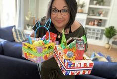 a woman is holding some boxes in her hands