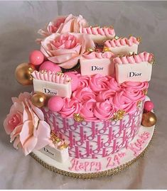 a birthday cake decorated with pink flowers and name tags for dior's day