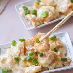 two white plates with shrimp and rice on them, one has chopsticks in it